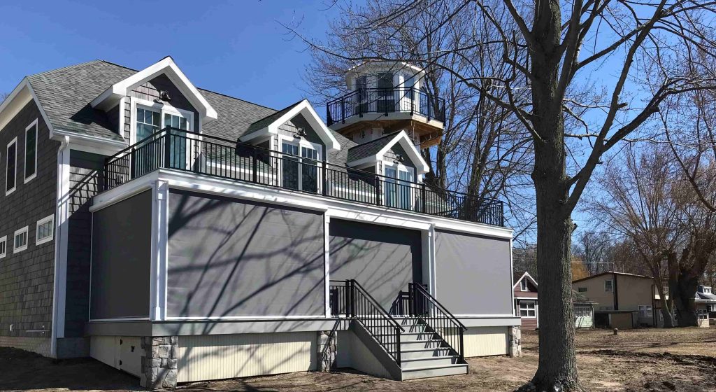 Sun shade protecting patio from outdoor elements